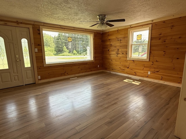 788 Access Hwy, Caribou, ME 04736 - foyer entrance featuring a textured ceiling, plenty of natural light, ceiling fan, wood finished floors, and wooden walls