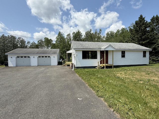 788 Access Hwy, Caribou, ME 04736 - view of front of property with entry steps, a detached garage, an outbuilding, a front lawn, and view of wooded area