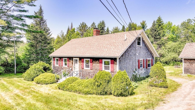 221 Lincolnville Ave, Belfast, ME 04915 - cape cod house with a chimney, a front lawn, a shingled roof, and dirt driveway