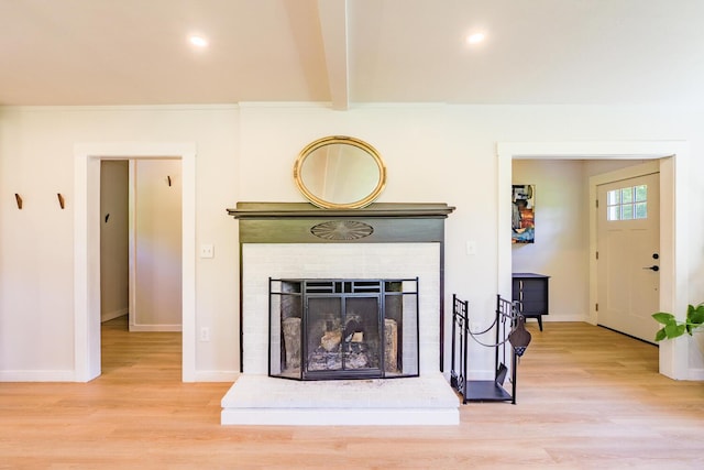 221 Lincolnville Ave, Belfast, ME 04915 - detailed view of wood finished floors, beam ceiling, a fireplace with raised hearth, and recessed lighting