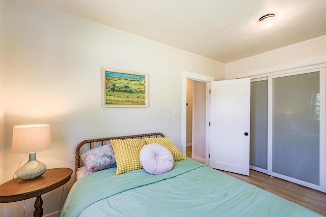 221 Lincolnville Ave, Belfast, ME 04915 - bedroom with wood finished floors, a closet, and ornamental molding