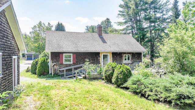 221 Lincolnville Ave, Belfast, ME 04915 - rear view of house with a chimney, a shingled roof, a yard, and a wooden deck
