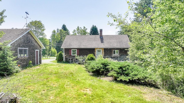 221 Lincolnville Ave, Belfast, ME 04915 - rear view of property featuring a yard, a chimney, and a shingled roof