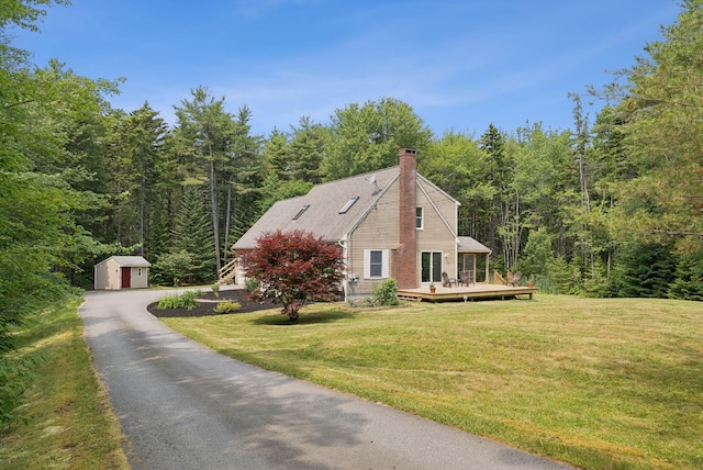 27 Libby Ln, Brunswick, ME 04011 - view of property exterior with a wooded view, a storage unit, a chimney, and a wooden deck