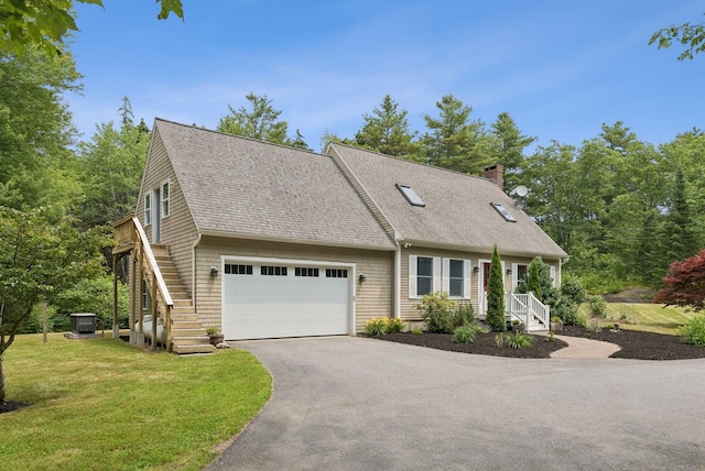 27 Libby Ln, Brunswick, ME 04011 - cape cod-style house featuring roof with shingles, asphalt driveway, a chimney, a front lawn, and a garage