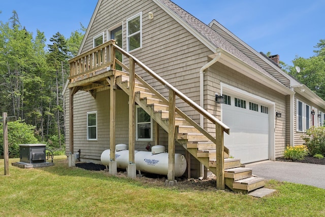 27 Libby Ln, Brunswick, ME 04011 - back of house with asphalt driveway, a yard, an attached garage, stairs, and a chimney