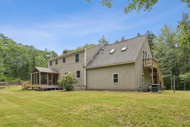 27 Libby Ln, Brunswick, ME 04011 - rear view of house with a sunroom, stairway, a chimney, a deck, and a lawn