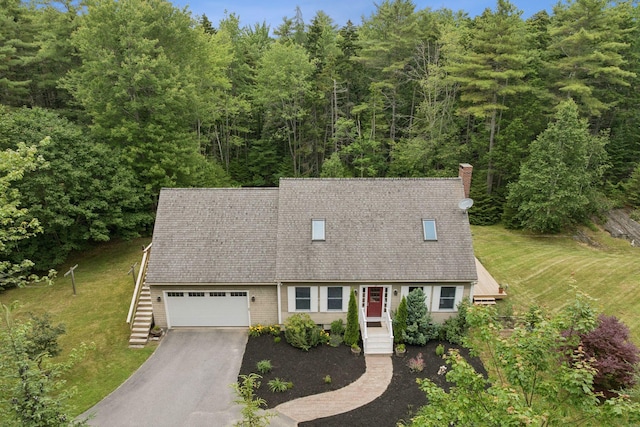 27 Libby Ln, Brunswick, ME 04011 - cape cod-style house featuring driveway, a garage, a chimney, roof with shingles, and a forest view