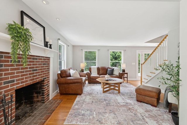 27 Libby Ln, Brunswick, ME 04011 - living room with wood finished floors, a brick fireplace, stairs, and recessed lighting