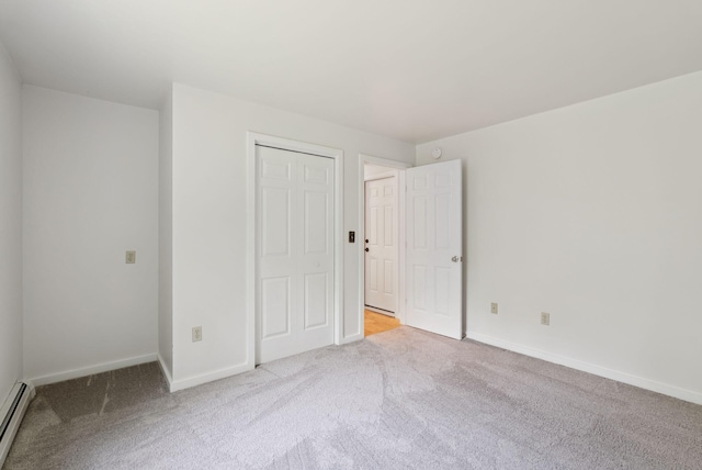 27 Libby Ln, Brunswick, ME 04011 - unfurnished bedroom featuring carpet, a baseboard radiator, and a closet
