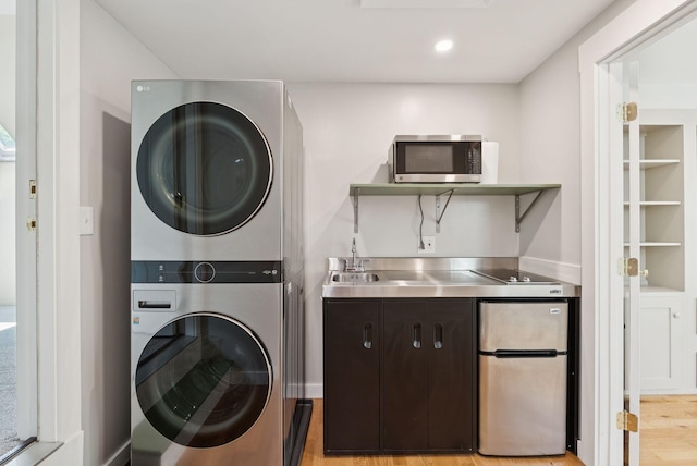 27 Libby Ln, Brunswick, ME 04011 - washroom featuring estacked washer and dryer and light wood finished floors