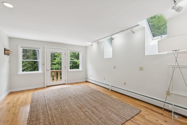 27 Libby Ln, Brunswick, ME 04011 - spare room featuring rail lighting, baseboard heating, a skylight, and wood finished floors