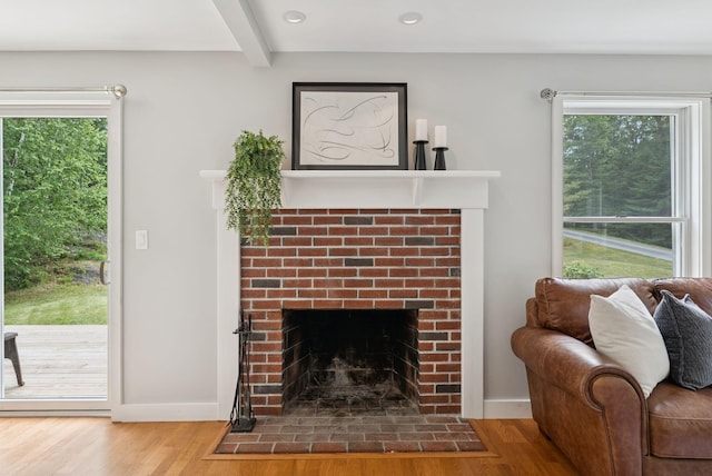 27 Libby Ln, Brunswick, ME 04011 - living area featuring a brick fireplace, wood finished floors, beamed ceiling, healthy amount of natural light, and recessed lighting