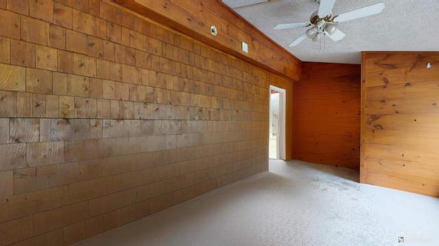 5 Wilson St, Lewiston, ME 04240 - unfurnished room with wooden walls, concrete flooring, a ceiling fan, and a textured ceiling