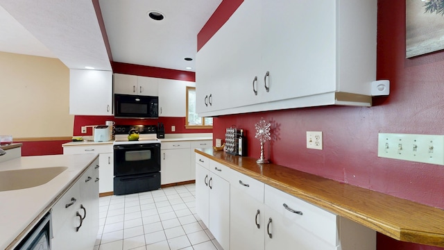 5 Wilson St, Lewiston, ME 04240 - kitchen featuring electric stove, black microwave, light tile patterned floors, white cabinetry, and recessed lighting