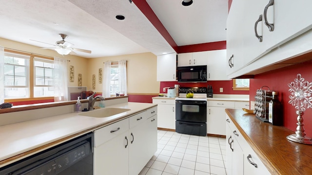 5 Wilson St, Lewiston, ME 04240 - kitchen featuring black appliances, light tile patterned floors, white cabinets, and a ceiling fan
