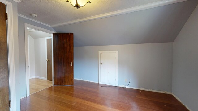 5 Wilson St, Lewiston, ME 04240 - additional living space featuring wood finished floors, lofted ceiling, and a textured ceiling