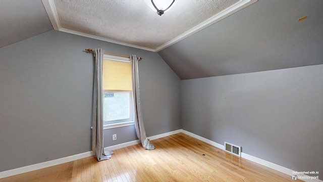 5 Wilson St, Lewiston, ME 04240 - bonus room with vaulted ceiling, a textured ceiling, and wood finished floors