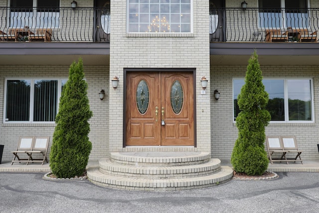 6 Grande Ave, Lewiston, ME 04240 - doorway to property with brick siding and a balcony