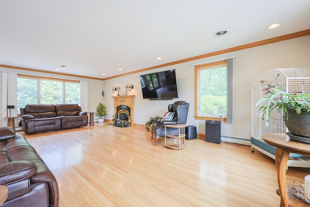 6 Grande Ave, Lewiston, ME 04240 - living area with ornamental molding, healthy amount of natural light, a baseboard heating unit, wood finished floors, and recessed lighting