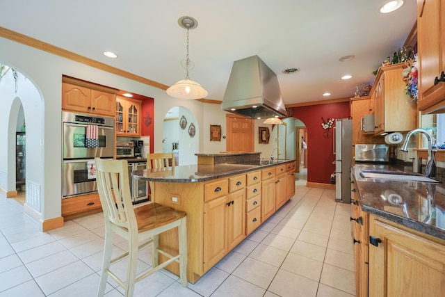 6 Grande Ave, Lewiston, ME 04240 - kitchen with arched walkways, double oven, island exhaust hood, freestanding refrigerator, and light tile patterned flooring