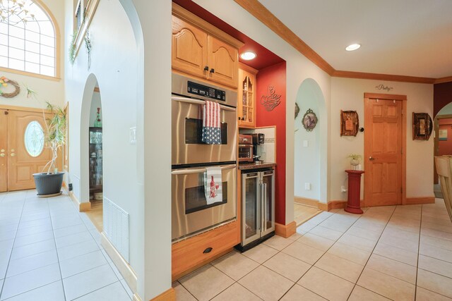 6 Grande Ave, Lewiston, ME 04240 - kitchen featuring stainless steel double oven, beverage cooler, arched walkways, light tile patterned floors, and recessed lighting