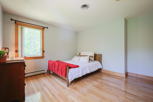6 Grande Ave, Lewiston, ME 04240 - bedroom with a baseboard heating unit and light wood-style floors