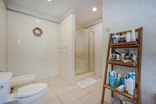 6 Grande Ave, Lewiston, ME 04240 - bathroom featuring tile walls, a shower stall, a bidet, and tile patterned flooring
