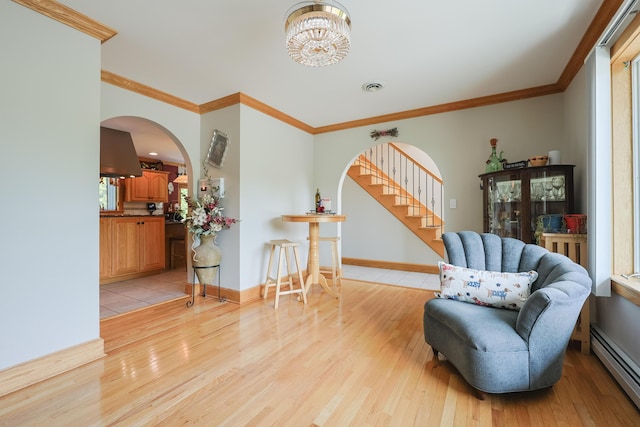 6 Grande Ave, Lewiston, ME 04240 - living area with baseboard heating, arched walkways, light wood-style flooring, crown molding, and stairway