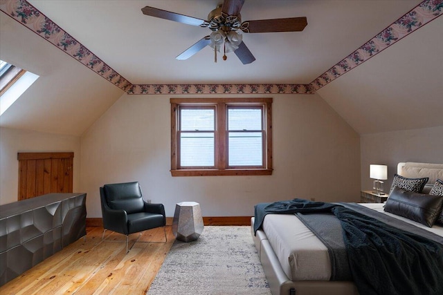 418 Buzzell Hill Rd, Hope, ME 04847 - bedroom with lofted ceiling, wood-type flooring, a ceiling fan, and a skylight