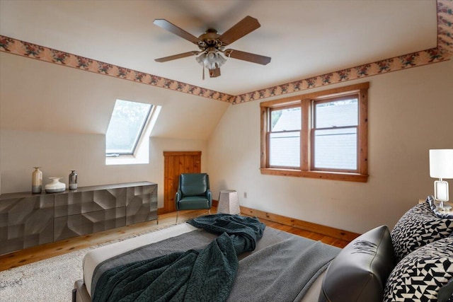 418 Buzzell Hill Rd, Hope, ME 04847 - bedroom with wood finished floors, lofted ceiling, a skylight, and a ceiling fan