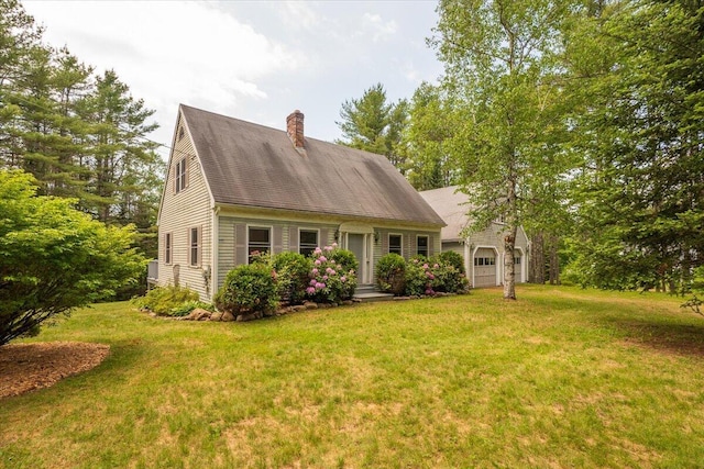 418 Buzzell Hill Rd, Hope, ME 04847 - cape cod house with a chimney, a front yard, and an attached garage