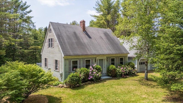 418 Buzzell Hill Rd, Hope, ME 04847 - cape cod house with a chimney, a front yard, and a garage