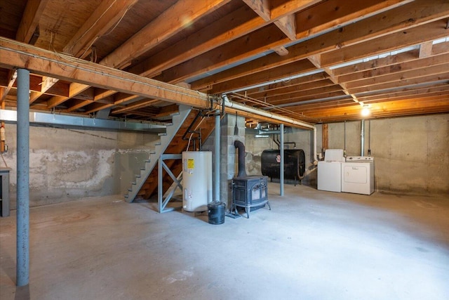 418 Buzzell Hill Rd, Hope, ME 04847 - unfinished basement with electric water heater, oil tank, washer and dryer, a wood stove, and stairs