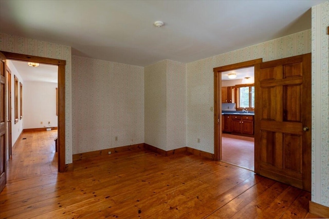 418 Buzzell Hill Rd, Hope, ME 04847 - empty room with wallpapered walls, light wood-type flooring, and a smoke detector