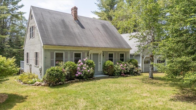 418 Buzzell Hill Rd, Hope, ME 04847 - cape cod-style house with a chimney, a front yard, and roof with shingles