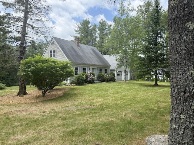 418 Buzzell Hill Rd, Hope, ME 04847 - cape cod home with a chimney, a front yard, and a garage