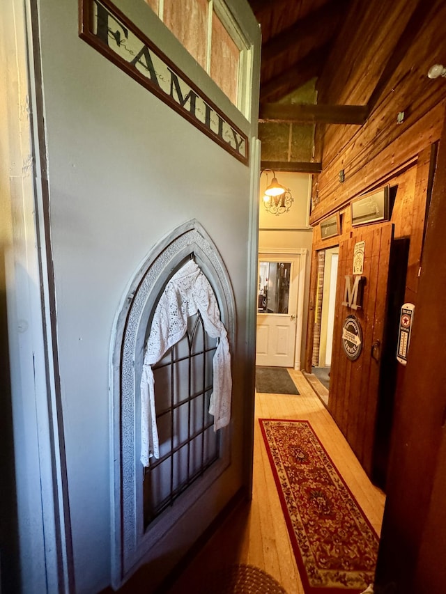164 Lancey St, Pittsfield, ME 04967 - hallway with wood walls, hardwood / wood-style floors, and beam ceiling
