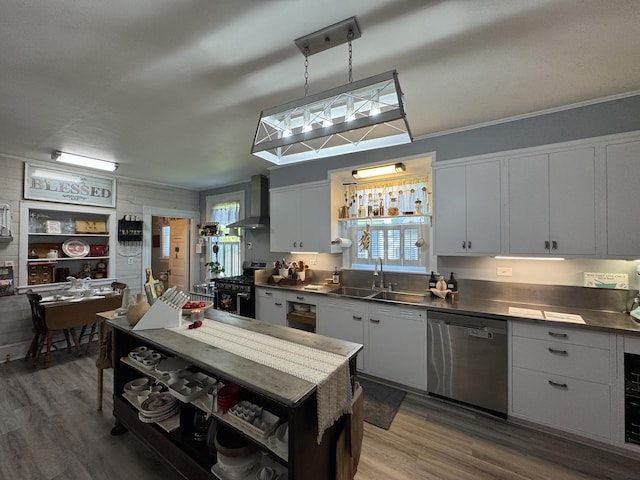 164 Lancey St, Pittsfield, ME 04967 - kitchen featuring stainless steel appliances, wall chimney exhaust hood, healthy amount of natural light, and wood finished floors