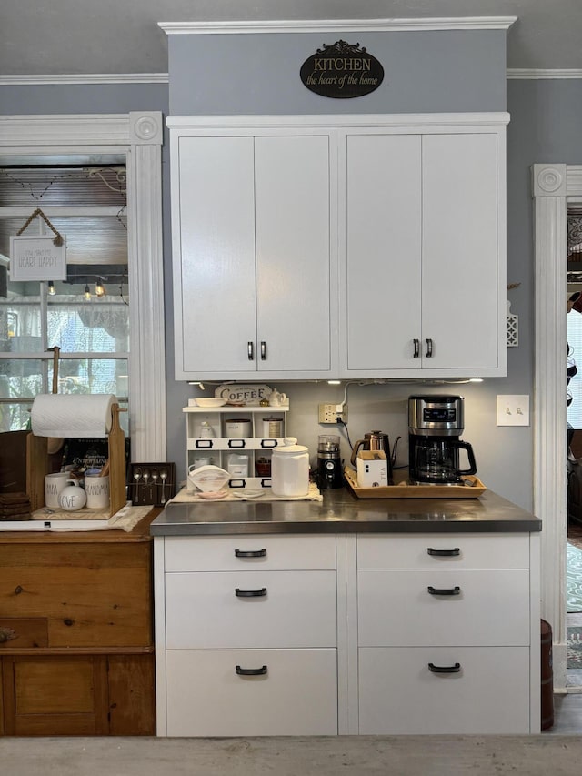 164 Lancey St, Pittsfield, ME 04967 - kitchen featuring stainless steel countertops, white cabinets, and crown molding