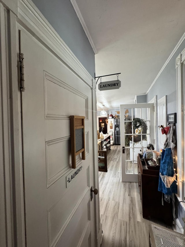 164 Lancey St, Pittsfield, ME 04967 - corridor featuring ornamental molding, light wood-style flooring, and french doors