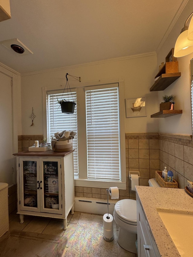 164 Lancey St, Pittsfield, ME 04967 - bathroom featuring tile walls, vanity, ornamental molding, and a wainscoted wall
