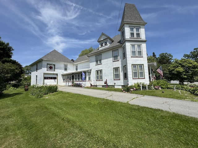 164 Lancey St, Pittsfield, ME 04967 - victorian home featuring a front lawn, concrete driveway, a shingled roof, and an attached garage