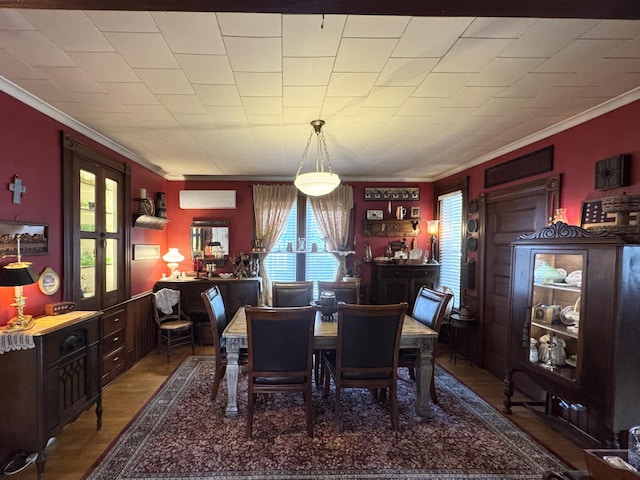 164 Lancey St, Pittsfield, ME 04967 - dining area with an AC wall unit, ornamental molding, and wood finished floors
