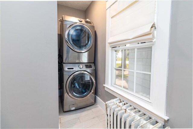 3 Dion St, Lewiston, ME 04240 - laundry room with stacked washer / dryer and radiator heating unit