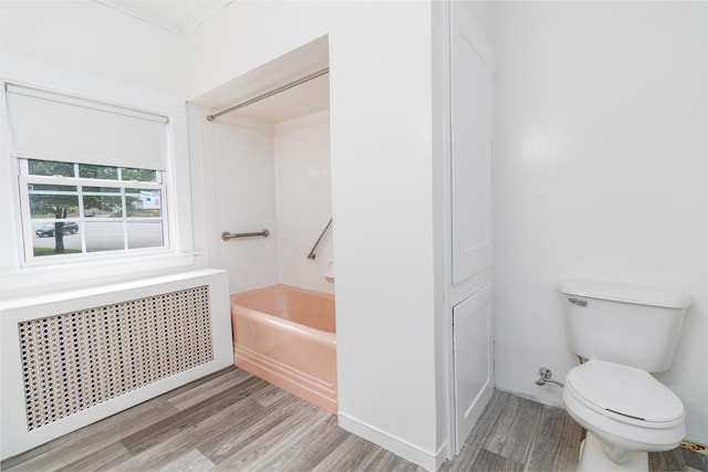 3 Dion St, Lewiston, ME 04240 - bathroom featuring radiator heating unit, wood finished floors, and shower / tub combination
