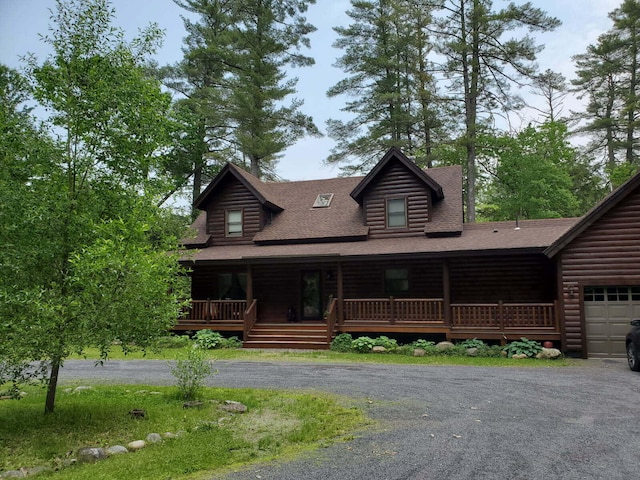 32 Lake Como Dr, Harmony, ME 04942 - log cabin with a shingled roof, a porch, and asphalt driveway