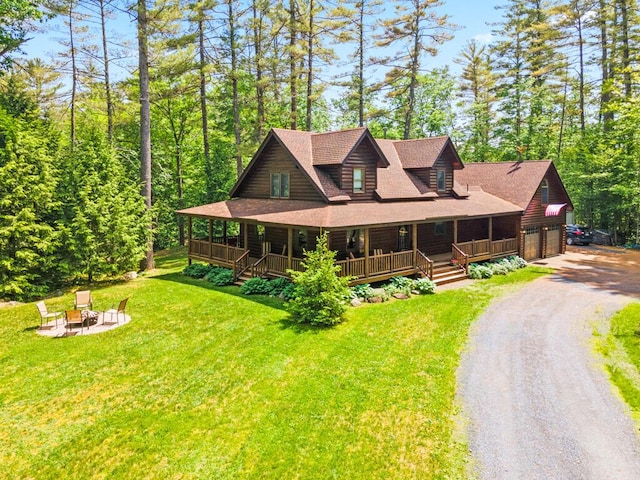 32 Lake Como Dr, Harmony, ME 04942 - log cabin featuring a fire pit, covered porch, a garage, driveway, and a front lawn