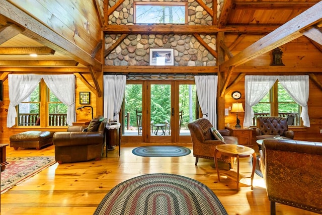 32 Lake Como Dr, Harmony, ME 04942 - living room with wooden walls, high vaulted ceiling, hardwood / wood-style flooring, beam ceiling, and french doors