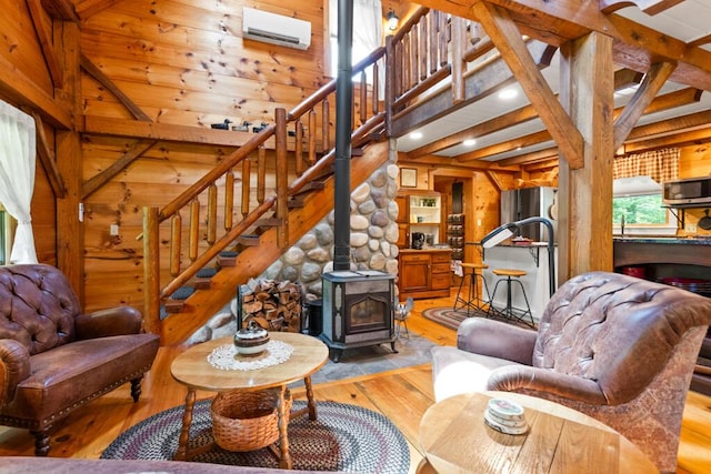 32 Lake Como Dr, Harmony, ME 04942 - living room featuring light wood-style floors, wooden walls, a wood stove, stairway, and recessed lighting